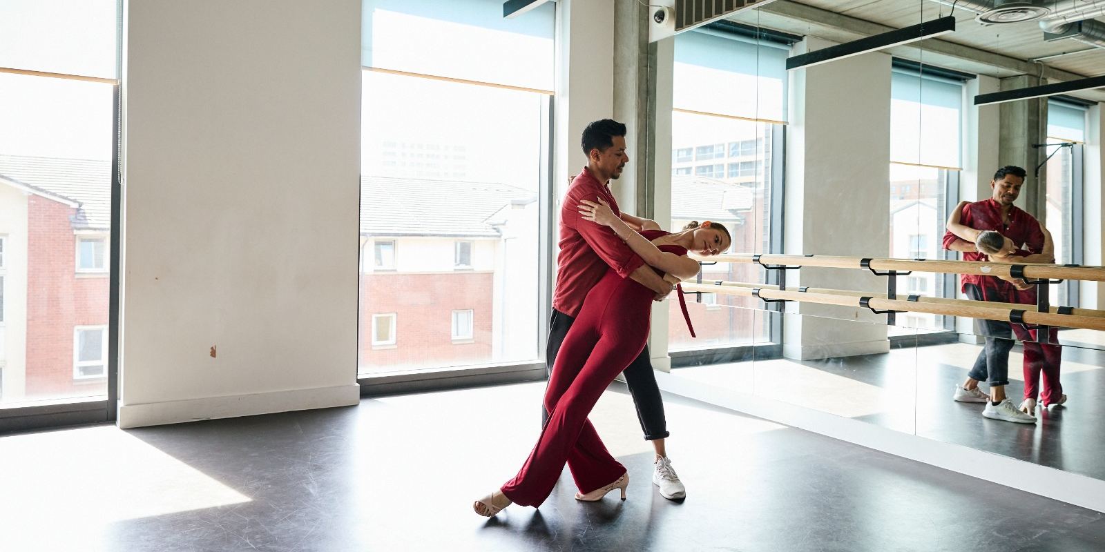 A couple finishing a bachata dance with a dip