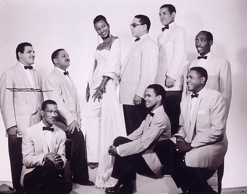 Black and white group photo of Celia Cruz with the musicians of La Sonora Matancera