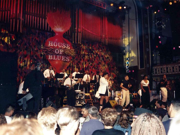 Tito Puente's orchestra performs on a stage in front of a crowd in Atlanta
