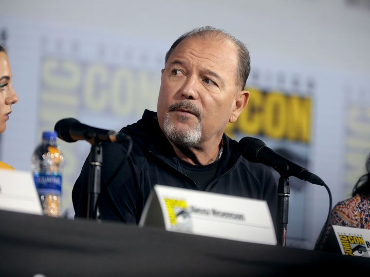 Rubén Blades speaks into a microphone at a panel discussion