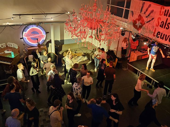 A busy dance hall full of couples dancing Cuban salsa at a club night