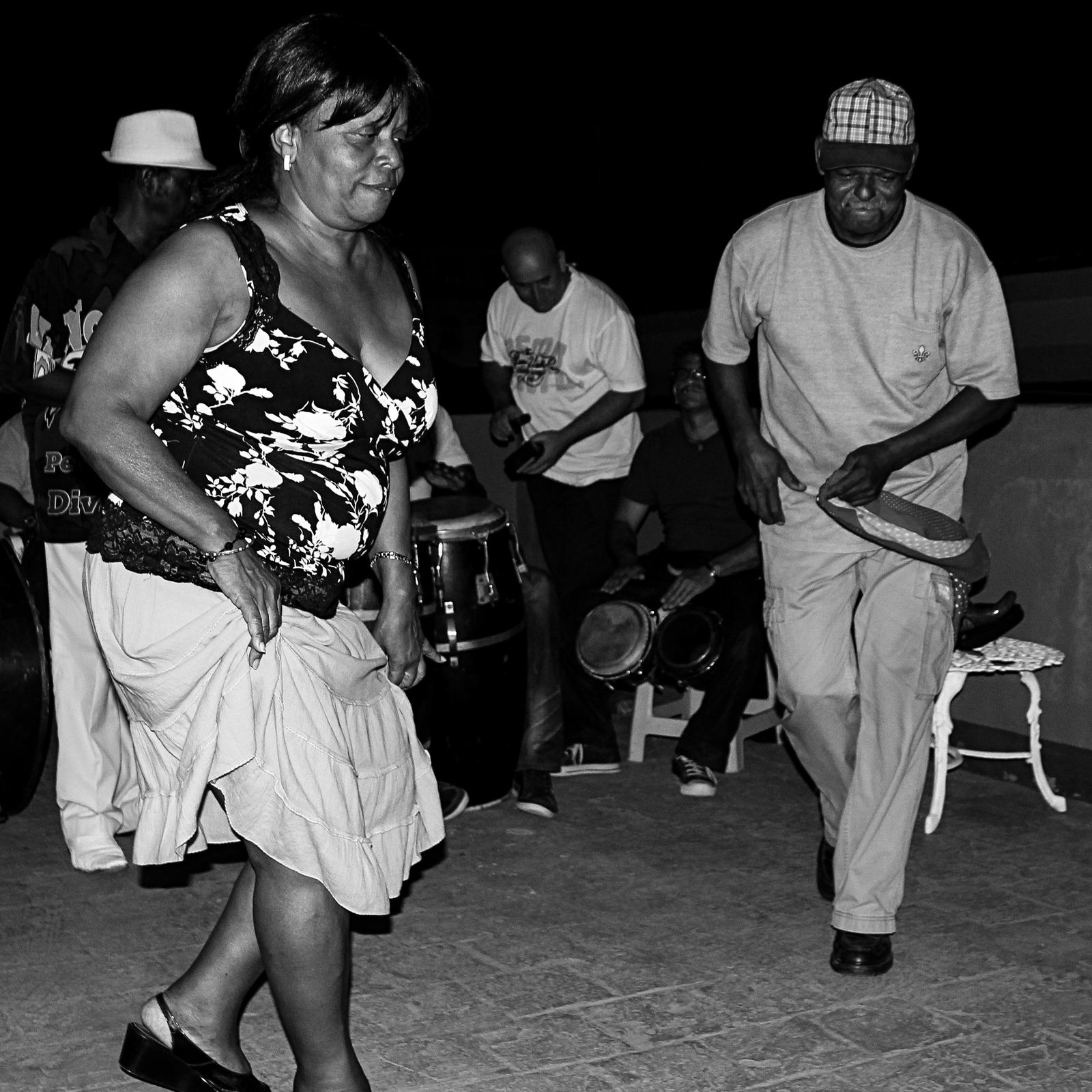 Black and white photo of people dancing to live drums on a Havana rooftop