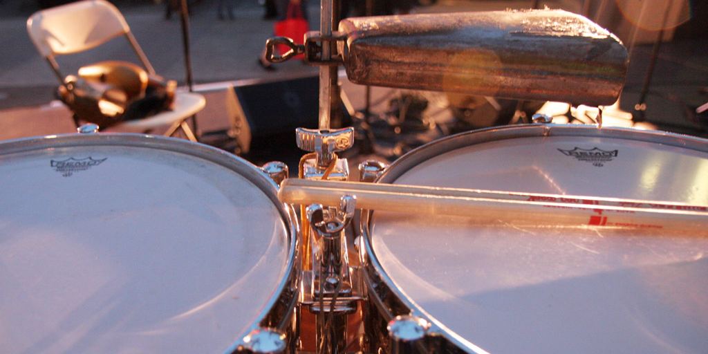 A set of timbales with cowbells mounted on a stand